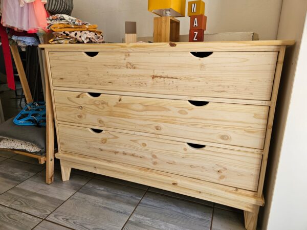 Raw wooden 3 drawer set in room