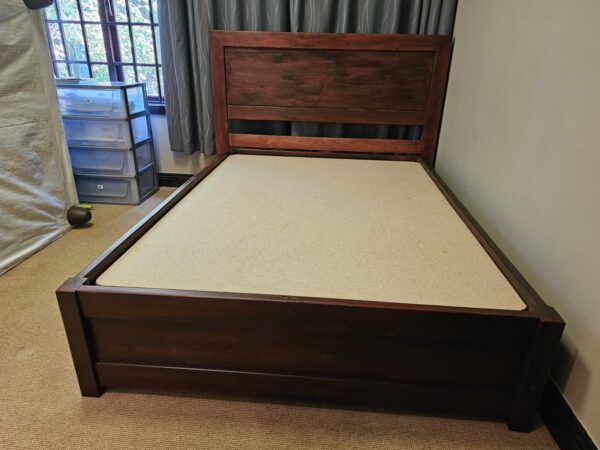 Dark stained wooden bed set front view without mattress