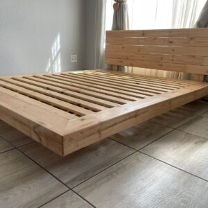 Wooden floating bed with mattress in bedroom