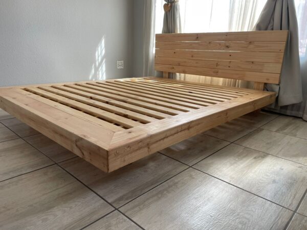 Wooden floating bed with mattress in bedroom