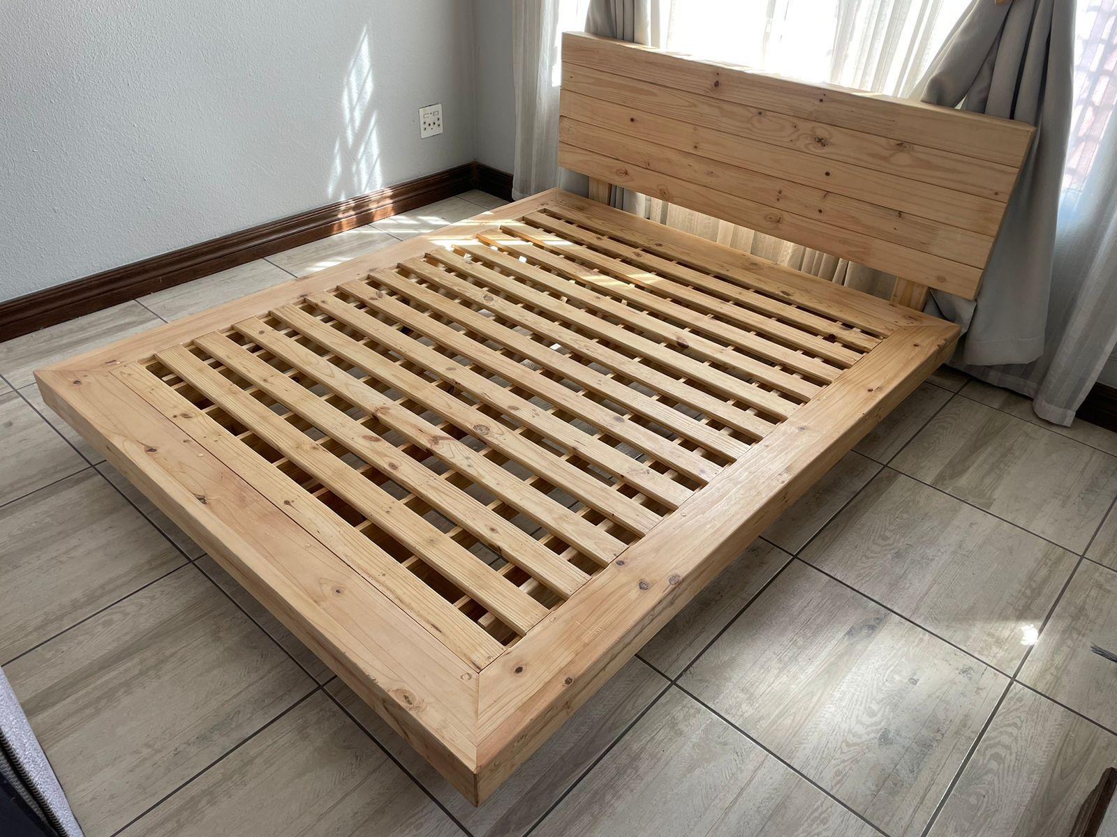 Wooden floating bed with headboard