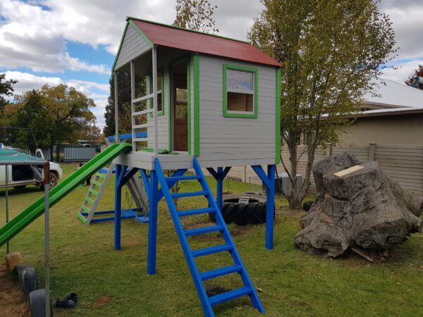 Wooden outdoor playhouse, grey and blue with green slide