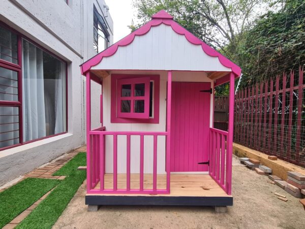 Pink and white wooden playhouse front view