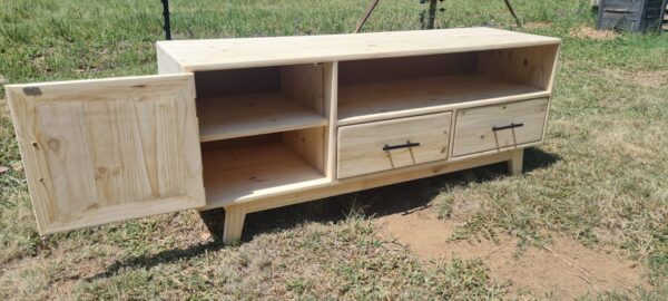 Raw wooden tv unit with 2 drawers side view with 1 cupboard with door open