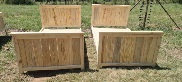 2 single raw wooden kids beds with headboards and footboards front view