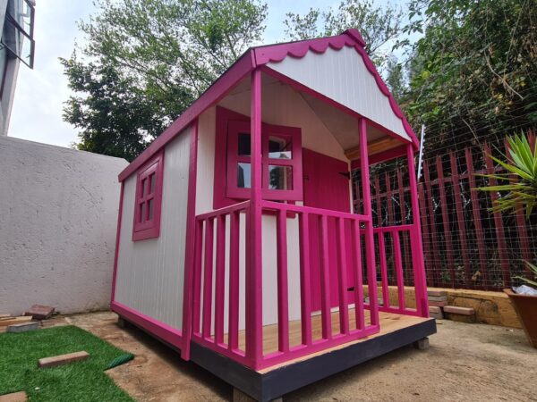 Pink and white wooden playhouse side angle view