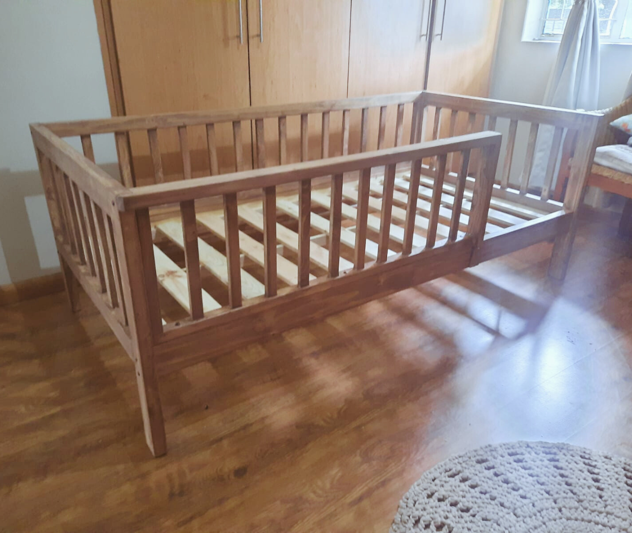 Wooden Crib to bed half rail bed stained outside