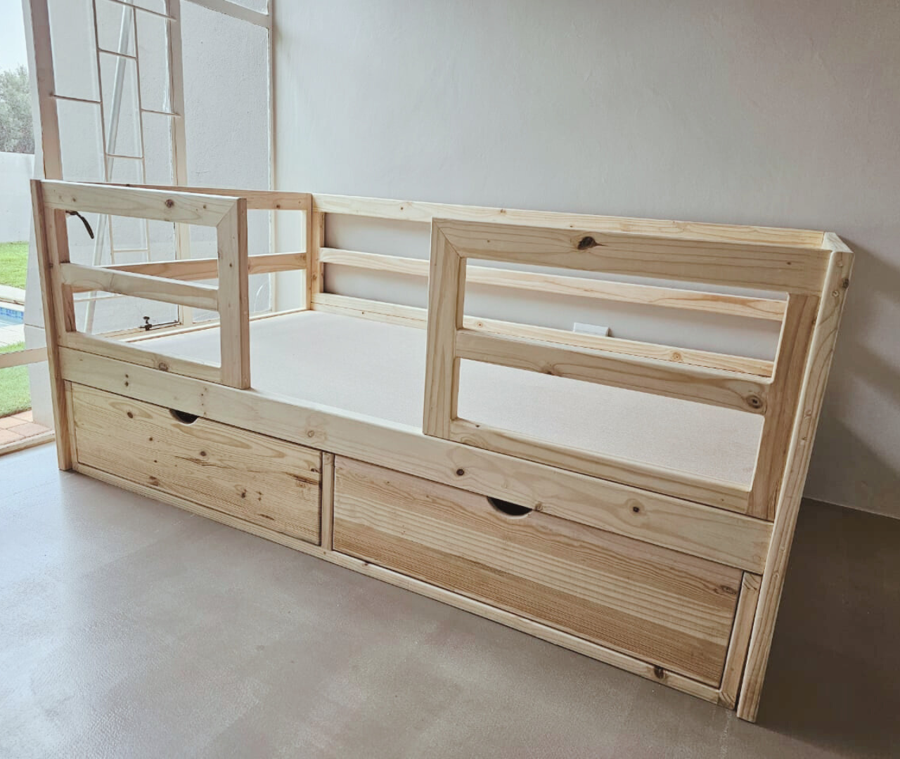 raw wood crib to bed rail bed with dusty pink sheet