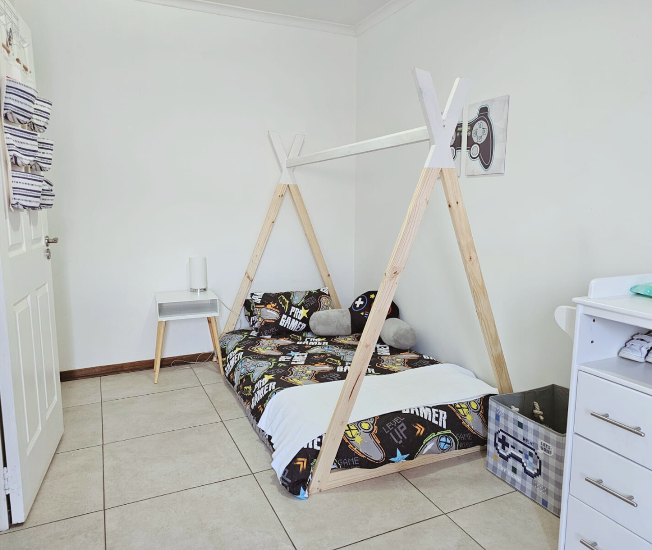 basic teepee bed with dark blue bedding