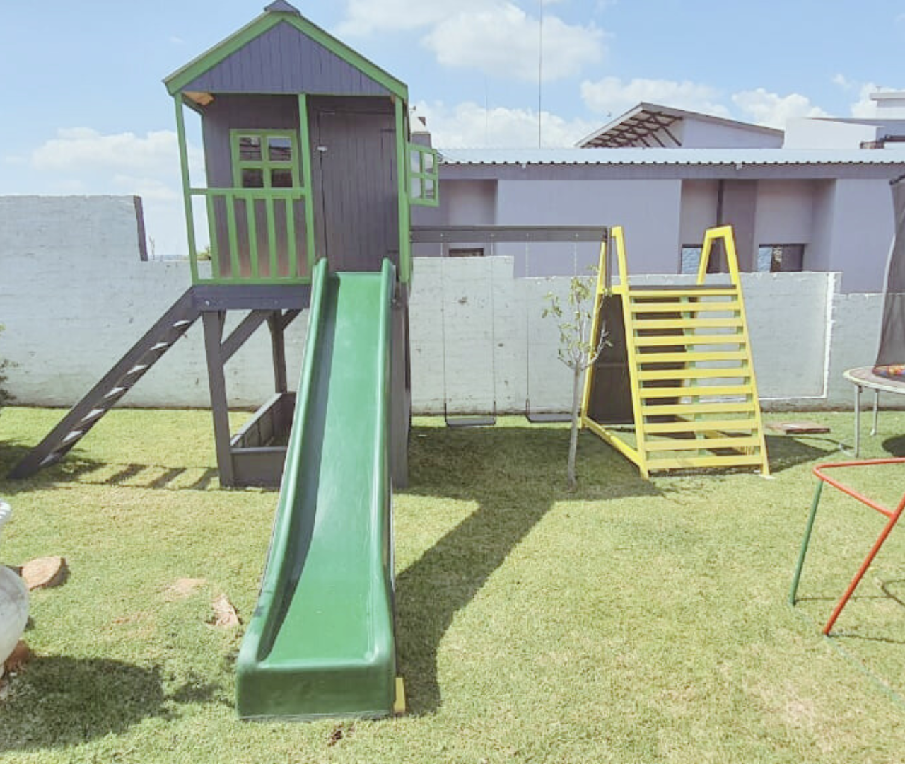 grey and green playhouse climbing gym