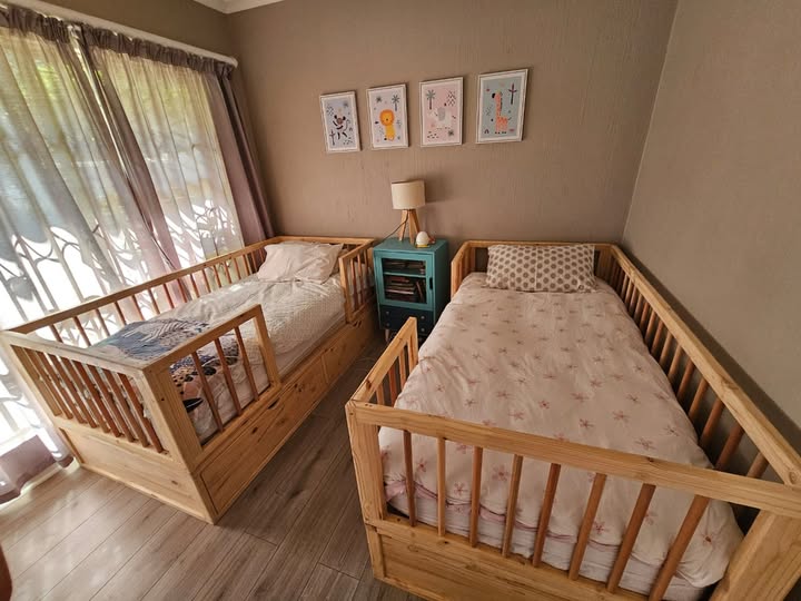 wooden railed kids bed with storage drawers