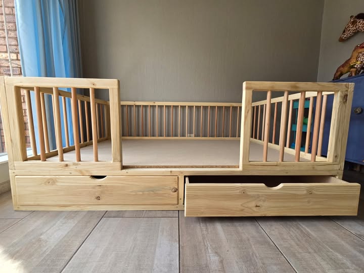 wooden railed kids bed with storage drawers