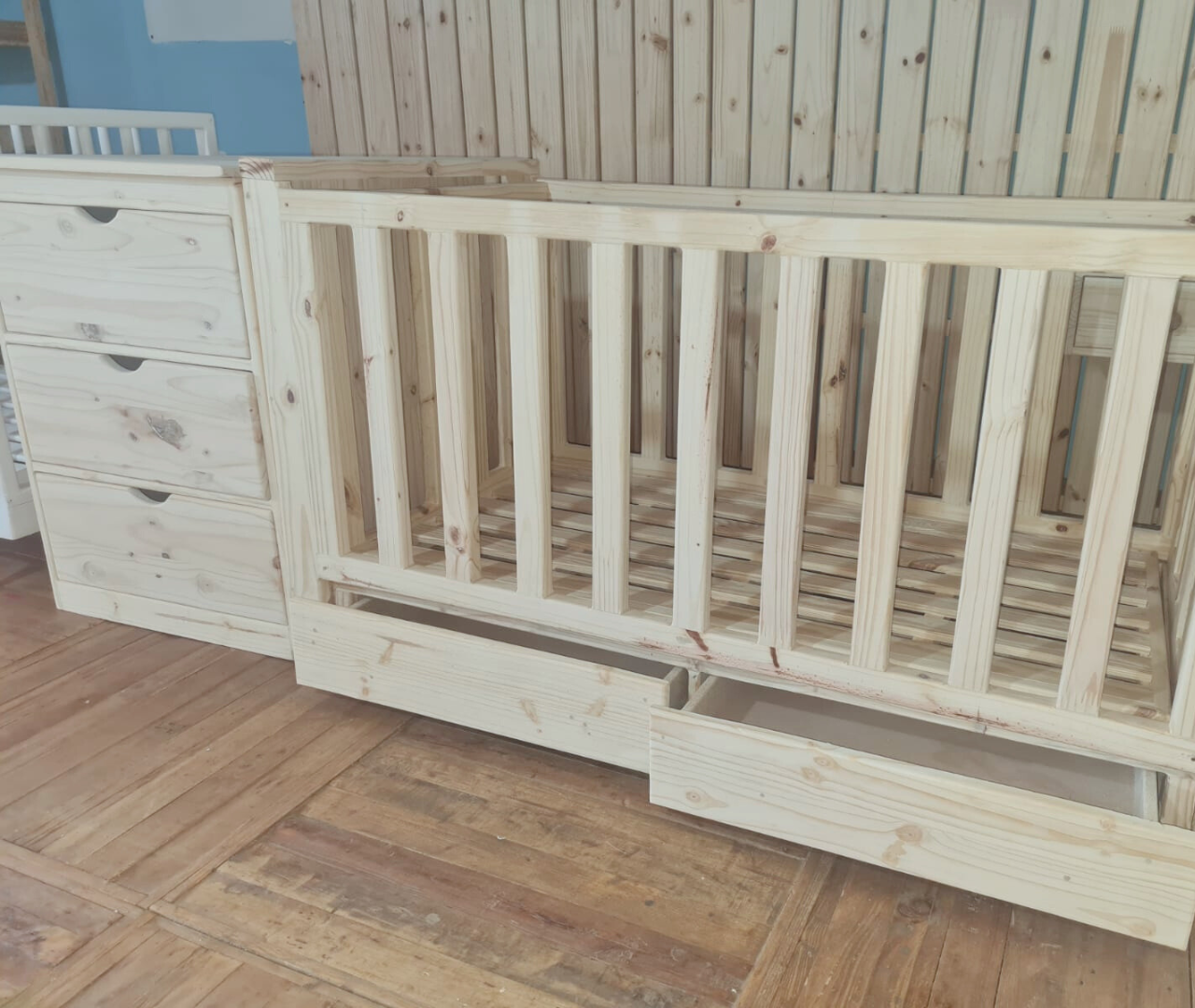 wooden railed kids bed with storage drawers