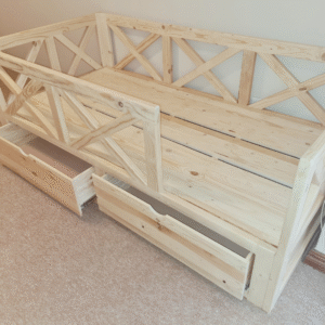 wooden railed kids bed with storage drawers