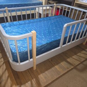 grey painted rounded crib bed with mattress