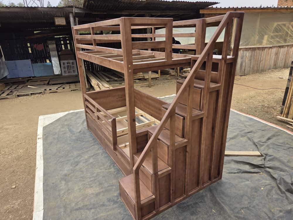 bunk bed with steps stained shown outdoors